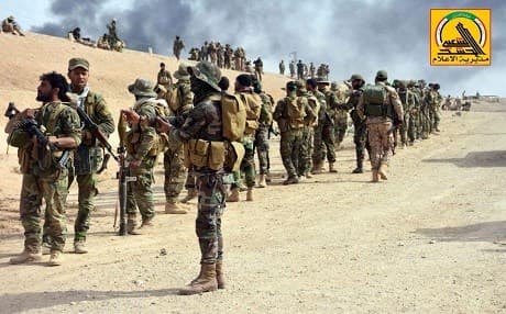 Fighters from the popular mobilization forces wait near the front lines during the ISIS war. Photo: Al-Hashd