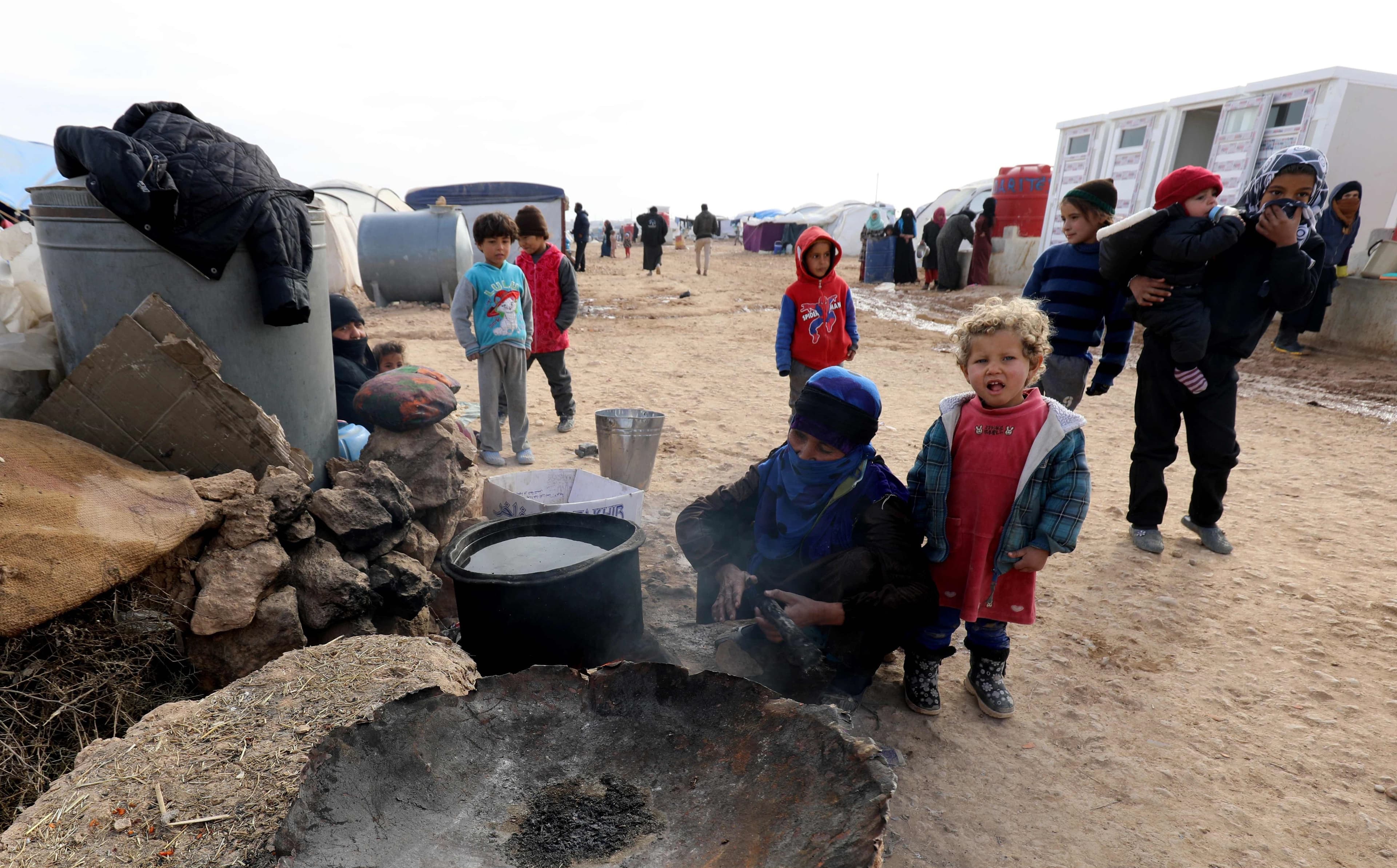Families displaced from Deir ez-Zor and Raqqa prepare food in Ain Issa camp last week. Photo: Delil Souleiman/AFP