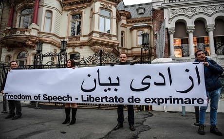 People hold a banner in support of protesters in Iran reading "Freedom of speech" in English, Romanian and Farsi during a protest outside the Iranian Embassy in the Romanian capital Bucharest on January 3. Photo: Daniel Mihailescu | AFP
