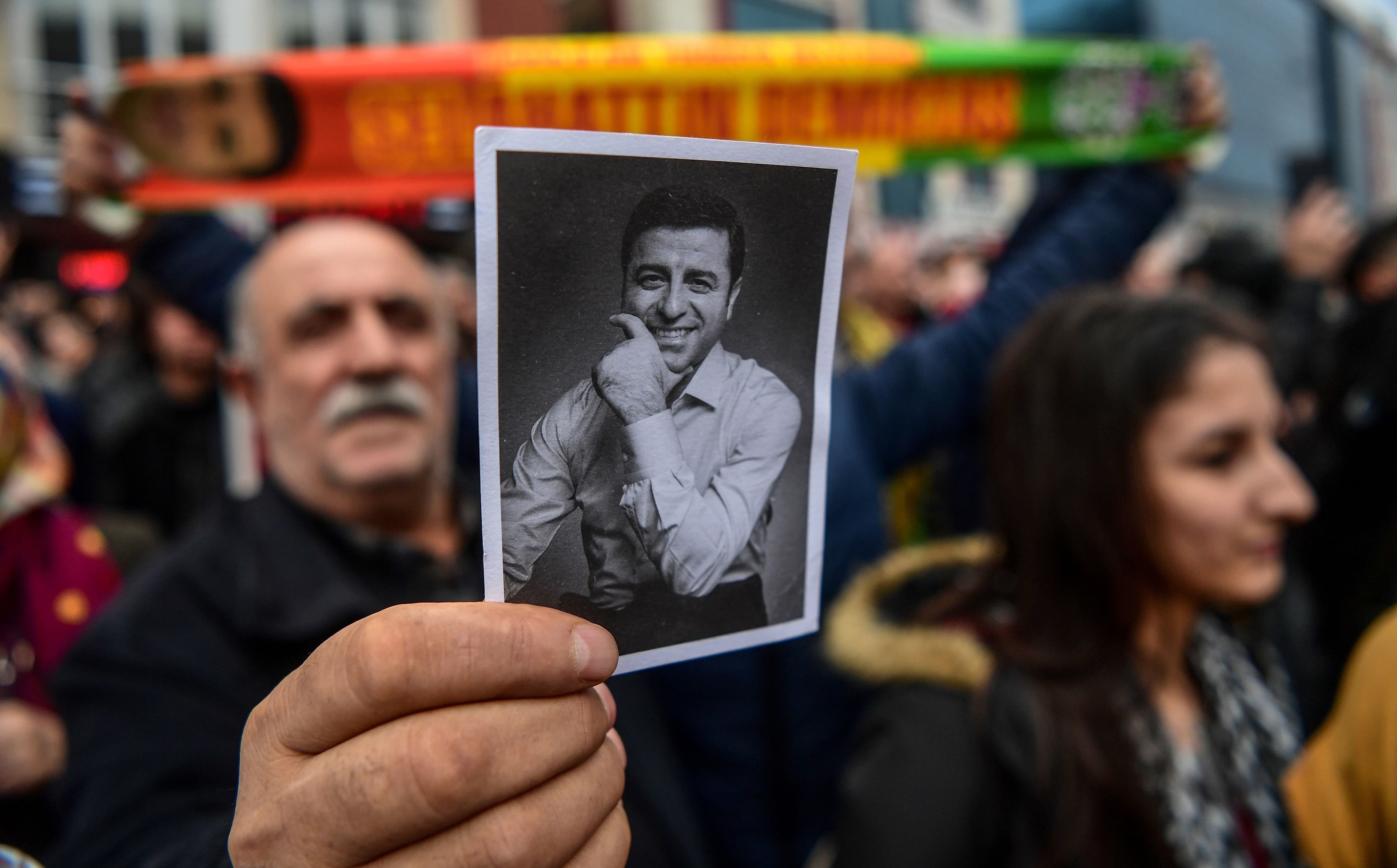 A supporter of Selahattin Demirtas hold a photo of the HDP leader outside the courthouse in Istanbul on Friday. Photo: Ozan Kose/AFP