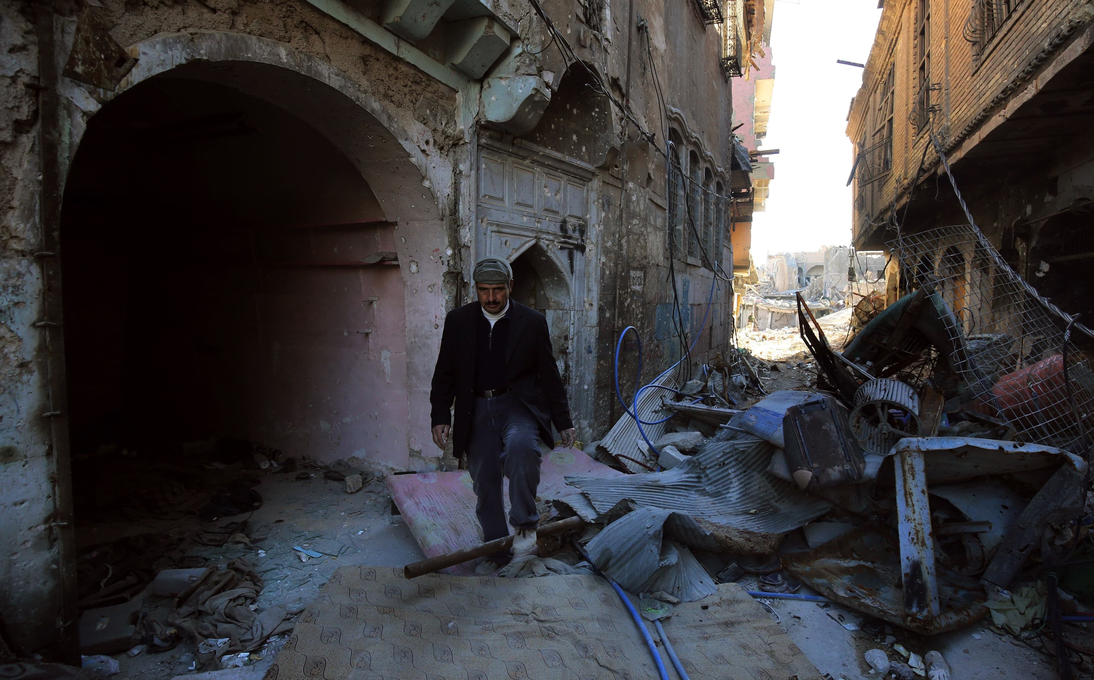 A man walks through rubble in an alley in Mosul’s Old City last week. Photo: Ahmad al-Rubaye/AFP