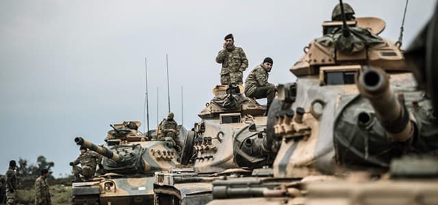 Turkish army tanks gather close to the Syrian border at Hassa in Hatay province on January 21, 2018. Photo: Bulent Kilic | AFP