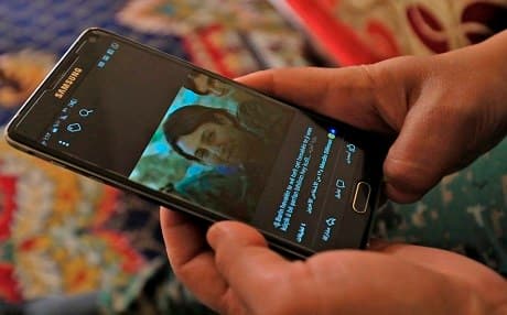 A picture taken on February 2, 2018 in the town of Afrin shows Amed Kendal, a military commander of the YPJ, displaying a picture of late 23-year-old Barin Kobani. Photo:  Delil Souleiman | AFP