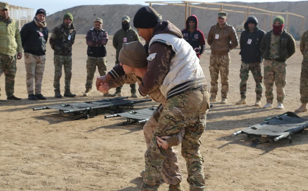 US Navy Corpsman teach Iraqi soldiers one way to carry a wounded soldier during training at al-Taqaddum, Iraq in January. Photo: Spc. Shannon Westpfahl/US Army