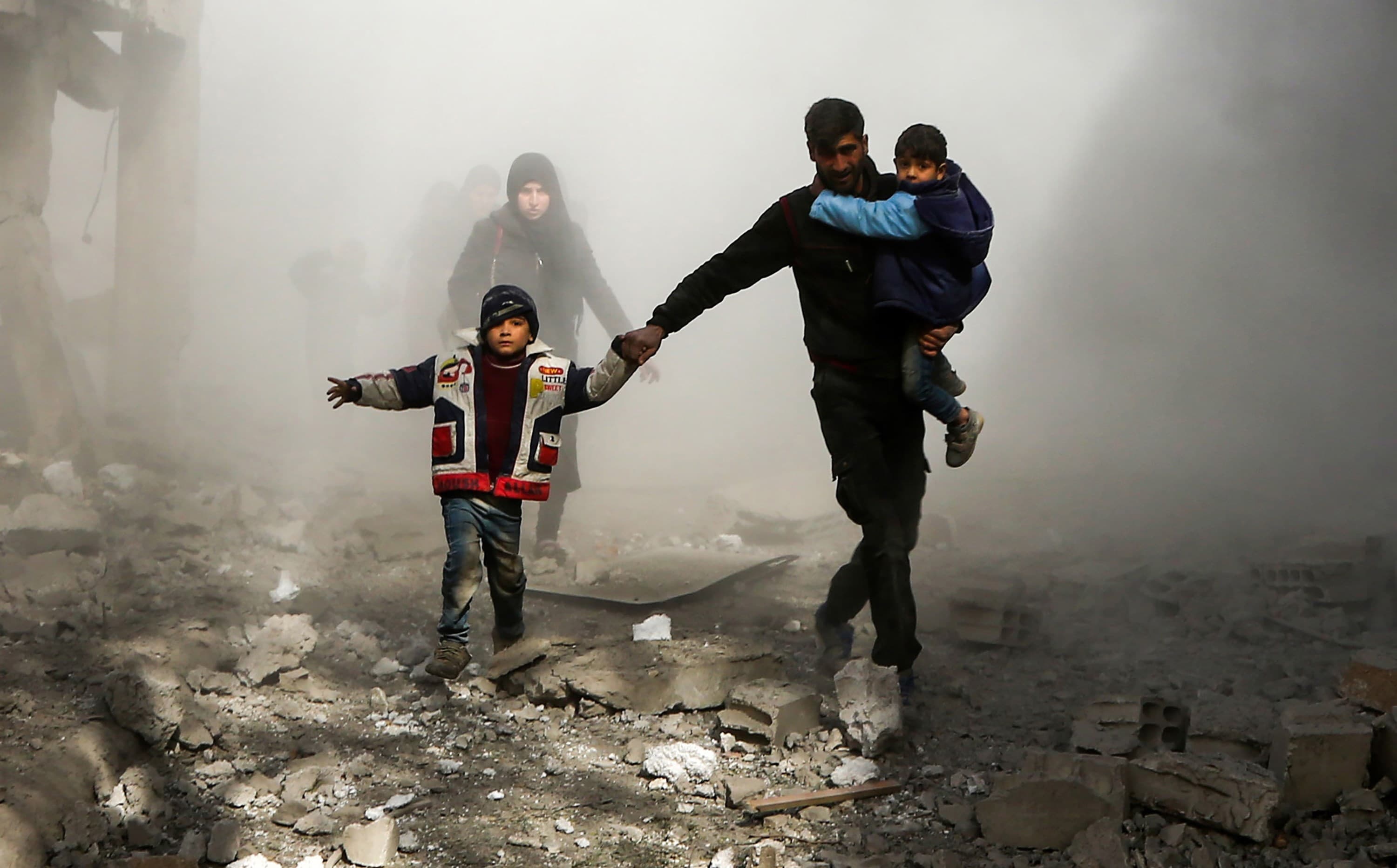 Syrian civilians flee reported regime airstrikes in the rebel-held town of Jisreen, Eastern Ghouta on Thursday. Photo: Abdulmonam Eassa/AFP