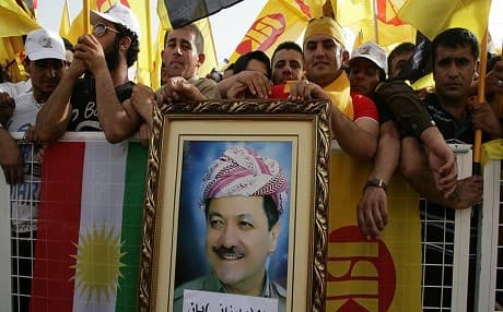 Supporters of Massoud Barzani (portrait), the leader of the KDP listen as he delivers a speech in Erbil on May 26, 2013. Photo: Safin Hamed | AFP