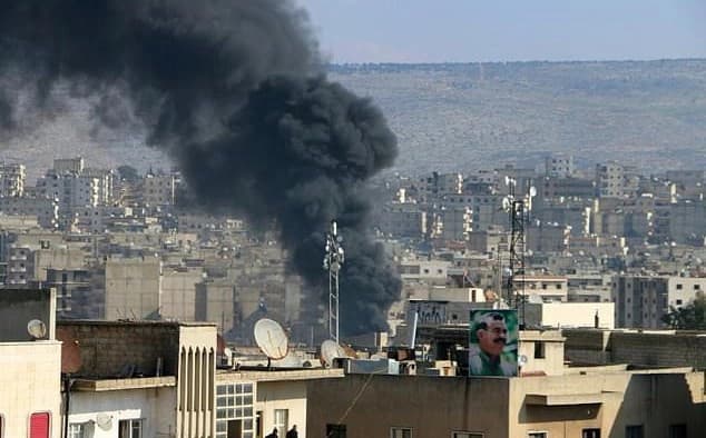 Smoke rises over Afrin city in late January. Photo: AFP