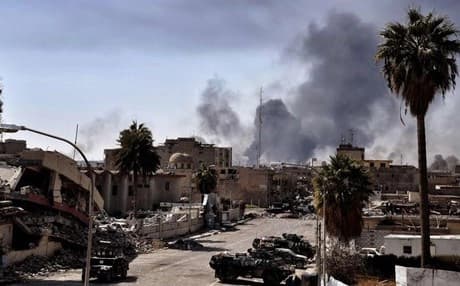 Smoke billows above Mosul as forces fought against ISIS in 2017. File photo: AFP