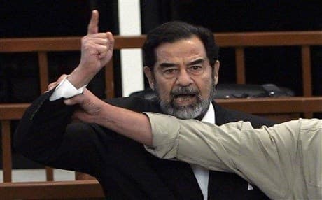 Executed Iraqi dictator Saddam Hussein yells at court as a bailiff attempts to silence him as the verdict is delivered during his trial in Baghdad in 2004. Photo: AP