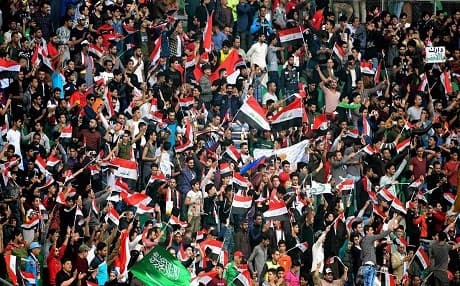 Iraqi and Saudi football fans cheer during a friendly football match between their countries in Basra, Iraq, on February 28, 2018. Photo: Nabil Al Jurani | AP