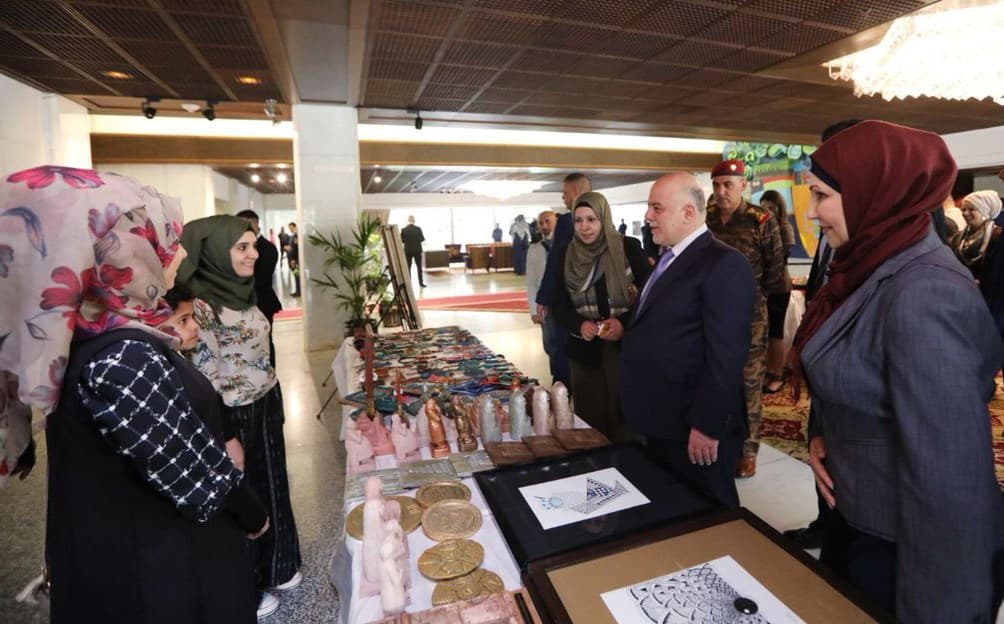Iraqi Prime Minister Haider al-Abadi speaks with women at a women’s day event on Wednesday. Photo: @HaiderAlAbadi