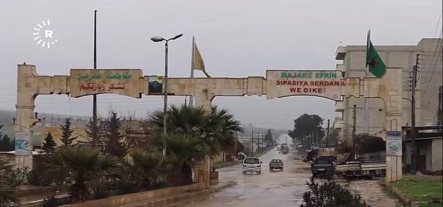 A sign reads 'Welcome to the city of Afrin' in Kurdish and Arabic, in northwestern Syria's Aleppo province in late February 2018.