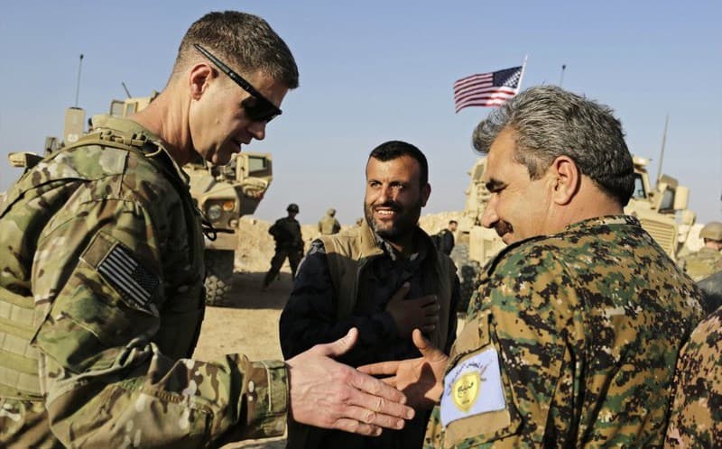 US Army Maj. Gen. Jamie Jarrod, left, shakes hands with Manbij Military Commander Muhammed Abu Adeel during a visit in February. Photo: Susannah George/AP
