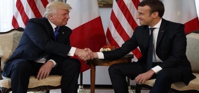 US President Donald Trump shakes hands with French President Emmanuel Macron. AP file photo