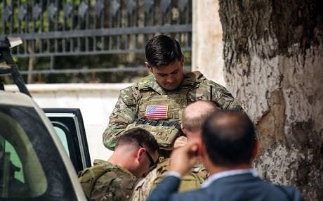 US soldiers accompany a US delegation including the commander of all US Special Forces to the YPG-held city of Manbij, where the US has a military presence, on March 22, 2018. Photo: Delil Souleiman | AFP