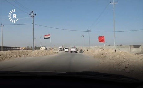 Iraqi and Hashd al-Shaabi flags fly at a checkpoint into the disputed city of Makhmour in February. File photo: Rudaw TV