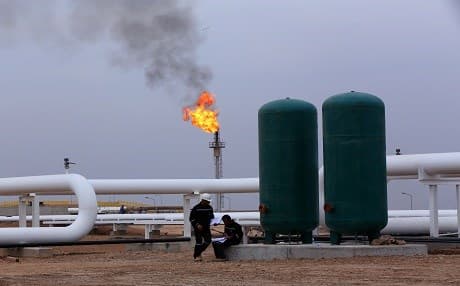 Workers perform maintenance to an oil facility in the Kurdistan Region. File photo: Rudaw