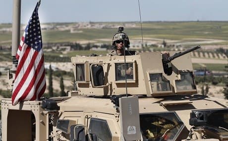 A US soldier sits in an armoured vehicle in Manbij, on a road leading to the frontline with Turkish-backed militias this week. Photo: Hussein Malla/AP