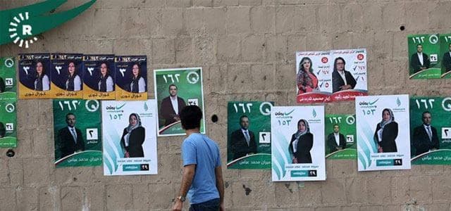 A man walks past posters of candidates from different political parties in the city of Sulaimani. Photo: Rudaw/Sartip Othman
