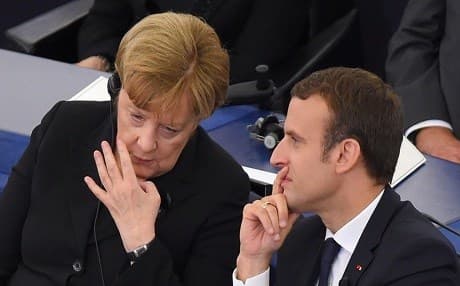 German Chancellor Angela Merkel and Emmanuel Macron chat in Strasbourg, France, in July 2017. Photo: EU