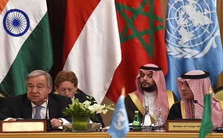 Saudi Foreign Minister Adel al-Jubeir (R) looks at the United Nations Secretary-General Antonio Guterres addressing the 16th Advisory Board meeting of the United Nations Counter-Terrorism Centre in Riyadh on April 17, 2018. Photo: Fayez Nureldine | AFP
