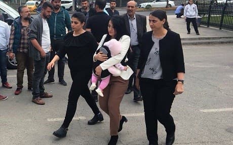 Ayse Celik and her child are seen on Friday. She is sentenced to 15 months in jail. Photo: HDP