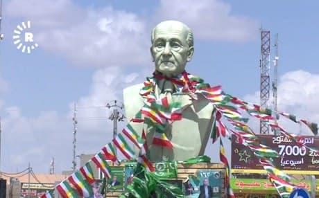 The statue of writer Aziz Pishtiwan in Khanaqin is festooned with Kurdistan flags and campaign materials. Photo: Rudaw