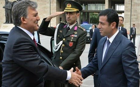 Former Turkish President Abdullah Gul and imprisoned former HDP co-chair Selahattin Demirtas greet each other outside the parliament in August 2014. Both their names have been floated as possible presidential candidates in snap elections. File photo: AP