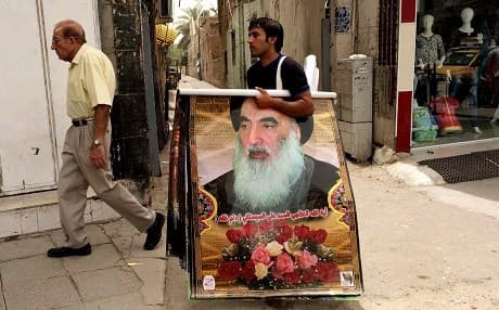 A vendor selling portraits of Ayatollah Ali al-Sistani. File photo: Khalid Mohammed/AP