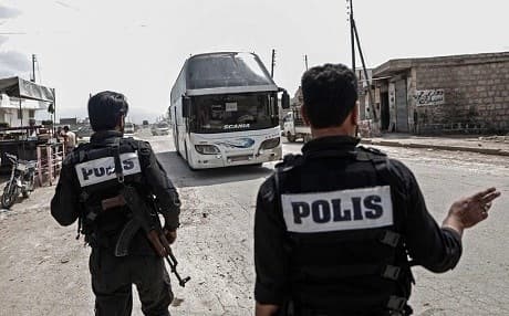 Turkish-backed forces seen coordinating the relocation of rebels and their families from Eastern Ghouta to Afrin in April. Photo: AFP