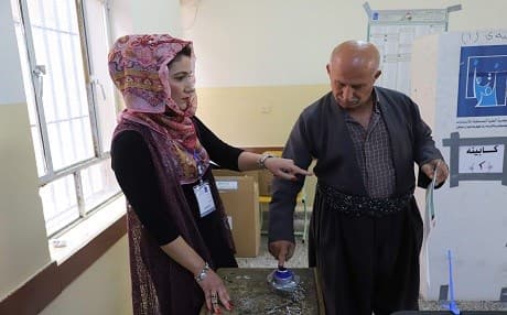 A Kurdish man dips his finger into ink at a polling station in Sulaimani city on May 12, 2018. Photo: Shwan Mohammed | AFP