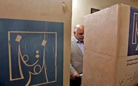 A handout picture released by Iraq's Prime Minister's Media Office on May 12, 2018 shows PM Haider al-Abadi ticking his ballot behind a voting booth at a poll station in the capital Baghdad's Karrada district. Photo: Iraqi PMO via AFP
