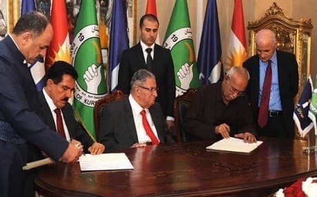 PUK and Gorran officials while signing a historic agreement in Sulaimani, with PUK leader Jalal Talabani seated in between on 17 May 2016. File photo: Rudaw