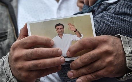 A supporter of the pro-Kurdish Peoples' Democratic Party (HDP) holds a picture of HDP's ex co-leader Selehattin Demirtas on May 25, 2018 during a campain meeting for the presidential elections near the prison where Demirtas is being held in Edirne. Photo: Ozan Kose / AFP