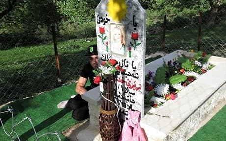 Adnan Jamil sits next to the grave of his wife Zeri Khuder Ismael in Lalish. She killed herself when ISIS attacked Shingal in 2014 to avoid being captured and raped. File photo: AC Robinson/Rudaw