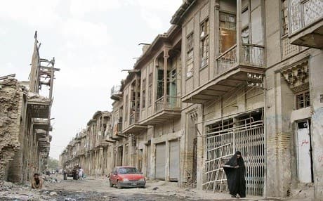 An Iraqi woman walks through a former Jewish quarter of Baghdad. File photo: Karim Kadim/AP