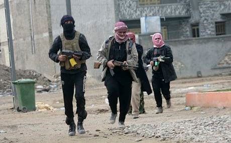 ISIS militants patrolling streets of Mosul shortly after seizing control of the city in summer 2014. File photo: AFP