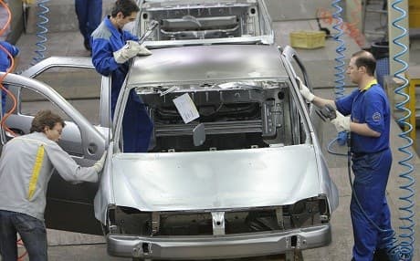 Iranian and French technicians work on a Renault Logan at the Iran Khodro auto plant, west of Tehran in July 2007. File photo: Behrouz Mehri/AFP
