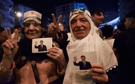 Women hold pictures of Selahatin Demirtas as they celebrate the results of the Turkish presidential and parliamentary elections in Diyarbakir (Amed), on June 24, 2018. Photo: Ilyas Akengin | AFP