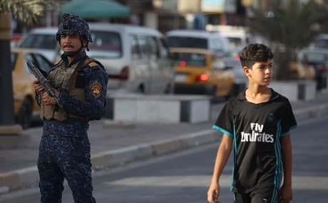 A member of the federal police patrols a street in Baghdad’s Shula district on Friday. Photo: Ahmad al-Rubaye/AFP