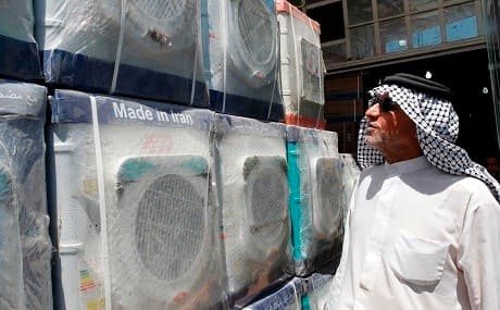 A customer looks at an Iranian-made washing machine at a store in the Iraqi capital, Baghdad on August 8, 2018. Photo: Sabah Arar / AFP