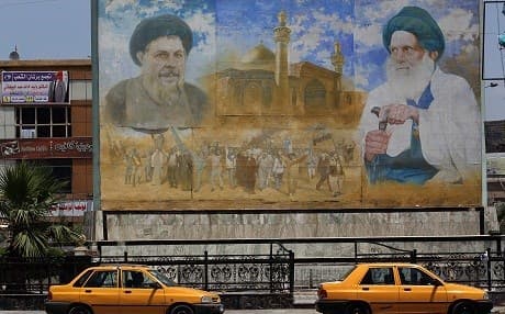 A poster shows Shiite leader Moqtada al-Sadr (left) and cleric Mohammed Baqer al-Sadr in Sadr City, east of the Iraqi capital Baghdad on May 14, 2018. Photo: Ahmad al-Rubaye