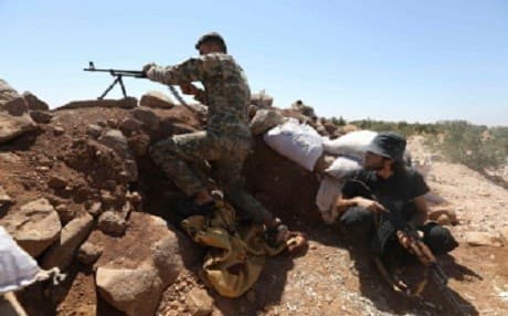 Rebel fighters from the Suqur Al-Sham brigades take a position in the countryside of the northern Idlib province on August 17, 2018. Photo: AFP/ Omar Haj Kadour