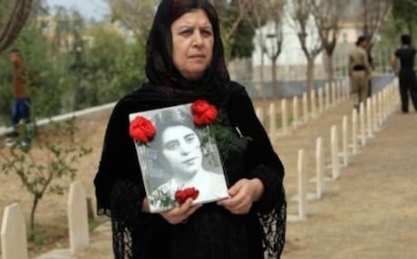 A Halabja woman visits the grave of her sister killed in the chemical gas attack of March 1988. Photo: AP