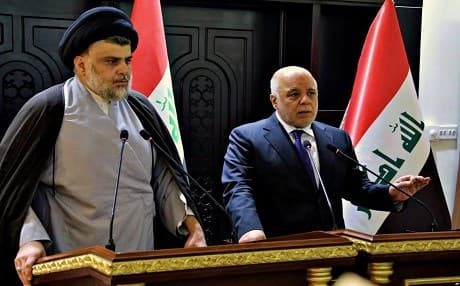Iraqi Prime Minister Haider al-Abadi (right) and Shiite cleric Muqtada al-Sadr, whose list won the most parliamentary seats, hold a press conference in Baghdad, May 20, 2018. File photo: AFP
