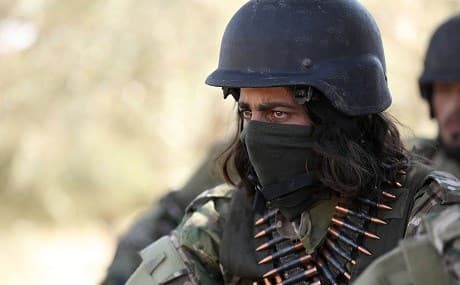 A Syrian rebel fighter looks on as men prepare for an upcoming government forces offensive, in the countryside of the rebel-held northern Idlib province, September 3, 2018. Photo: Omar Haj Kadour / AFP 