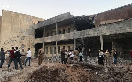 People gather at the headquarters of the PDKI, heavily damaged in a deadly Iranian missile strike on Saturday. Photo: Rudaw