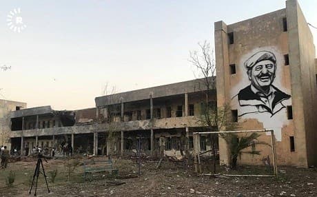 An portrait of Abdul Rahman Ghassemlou, former leader of the PDKI, overlooks the party’s headquarters in Koya, damaged in an Iranian missile strike. Photo: Rudaw