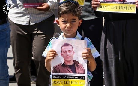 A child holds a poster appealing for the life of Ramin Hassan Panahi at a protest at the UN compound in Erbil earlier this year. File photo: Mohammed Shwani/Rudaw