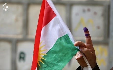A man hoists a Kurdistan flag after voting in the Iraqi parliamentary elections on May 12 in Sulaimani. Photo: Sartip Othman/Rudaw
